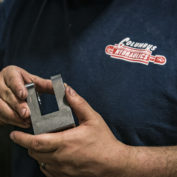 A person holding a hydraulic cylinder