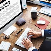 A desk with a desktop computer and keyboard