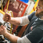 A person manufacturing custom hydraulic cylinders